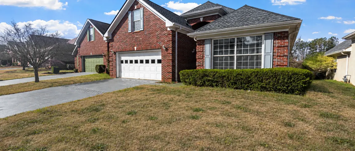 Before: a brick house with a thin, patchy front lawn and no planting